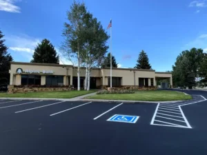 ADA-compliant parking lot striping with white lines and accessible parking space in Riverside, CA.